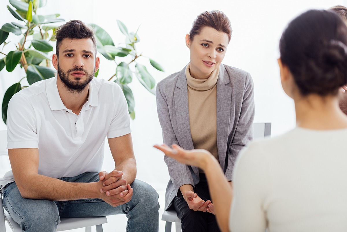 group of people sitting and having discussion during therapy session