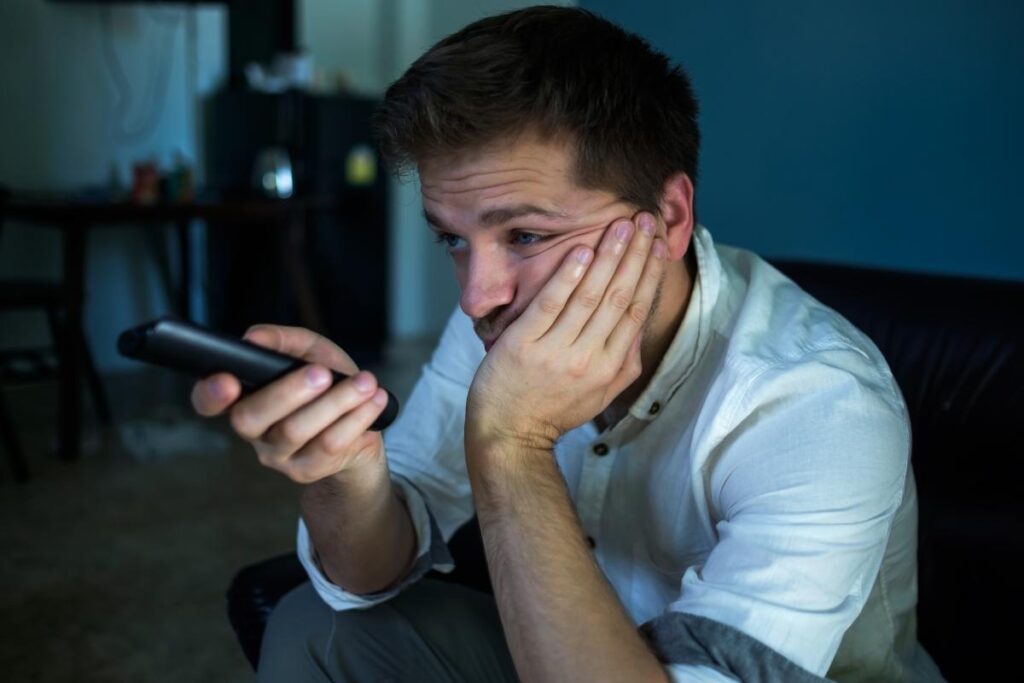 a person holds a remote possibly discovering the link between television and depression