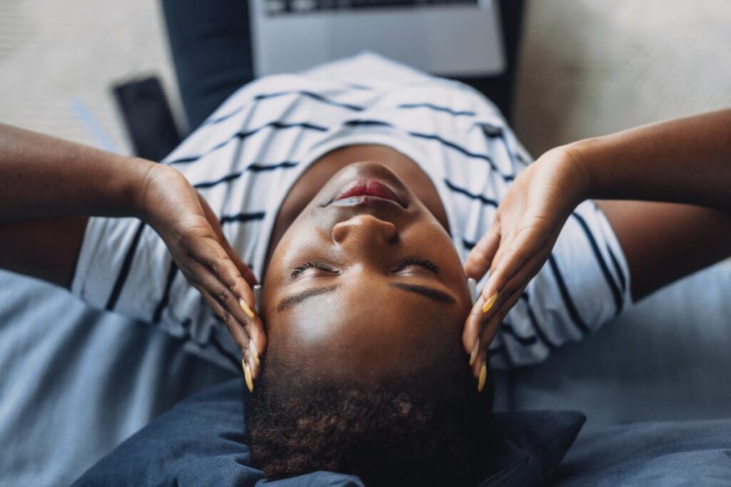 a person holds their head possibly struggling with an immune system on cocaine