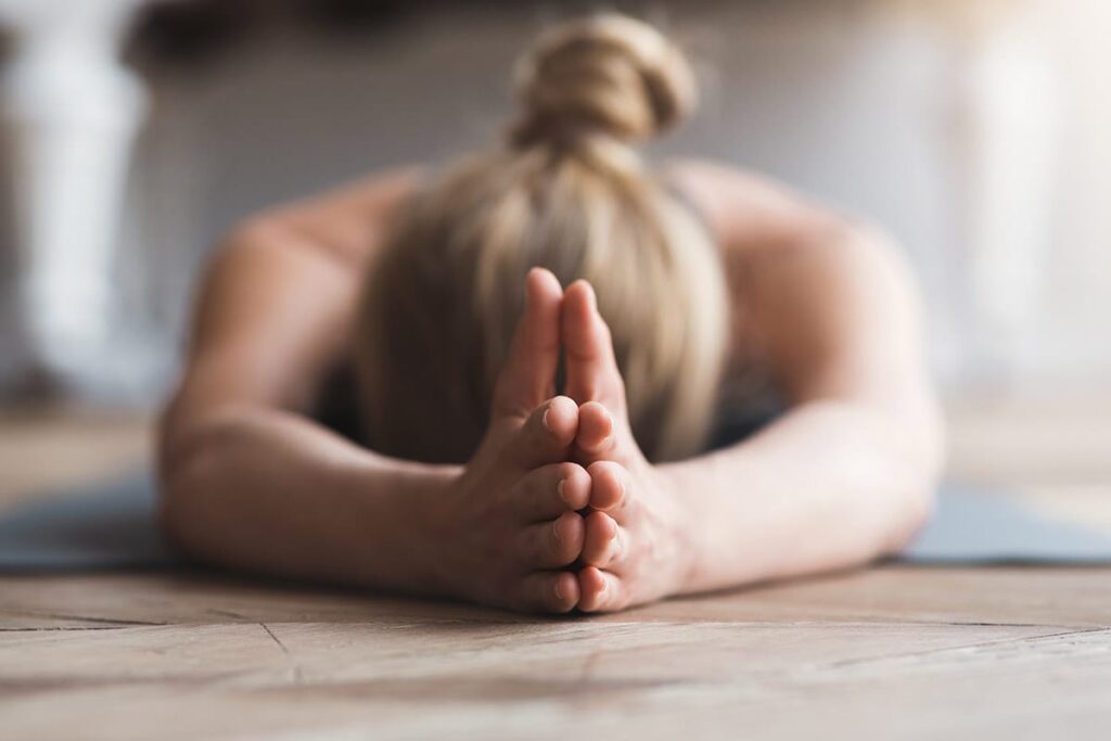 a person in a yoga pose learns the benefits of yoga for addiction