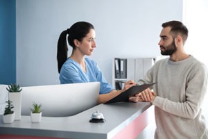 Man speaking to nurse about drug addiction treatment centers