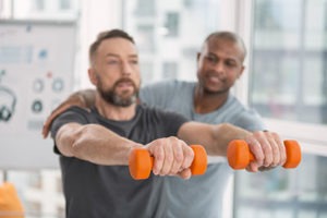 Man trains during his fitness therapy program