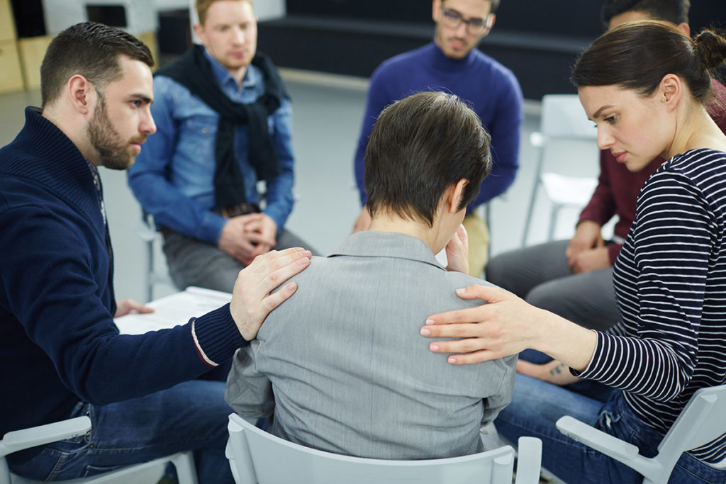 substance abuse recovery, patient in circle getting support from other patients