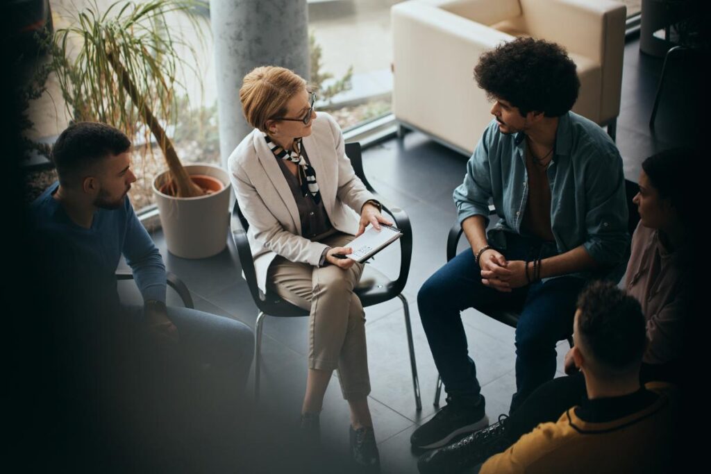 a person talks to a therapist in rehab for binge drinking