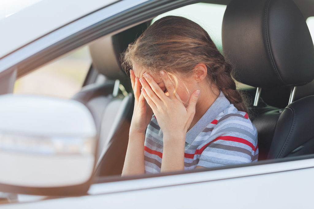 a teen girl covers her face as she thinks about 5 must know statistics teen drunk driving