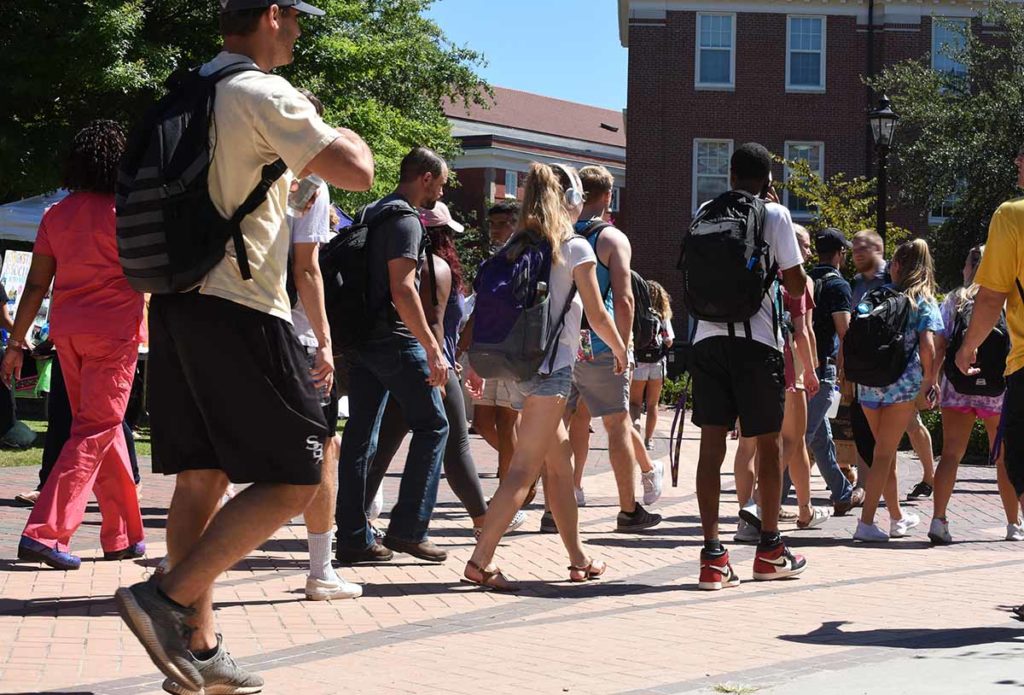 students walk to a lecture on 5 ways schools successfully reduced binge drinking