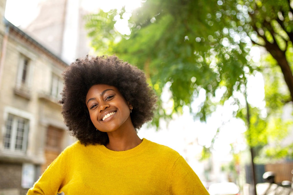 a woman smiles as she remembers an overview of the common steps toward successful rehab