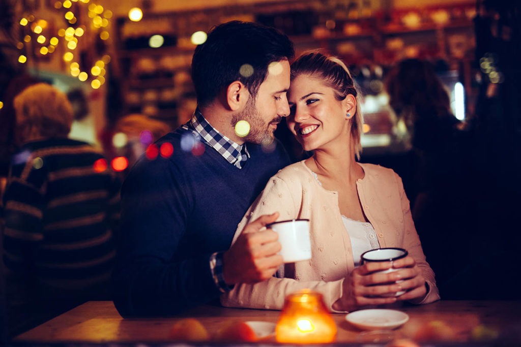 husband and wife talk about date night ideas when your spouse is a recovering alcoholic as they drink coffee