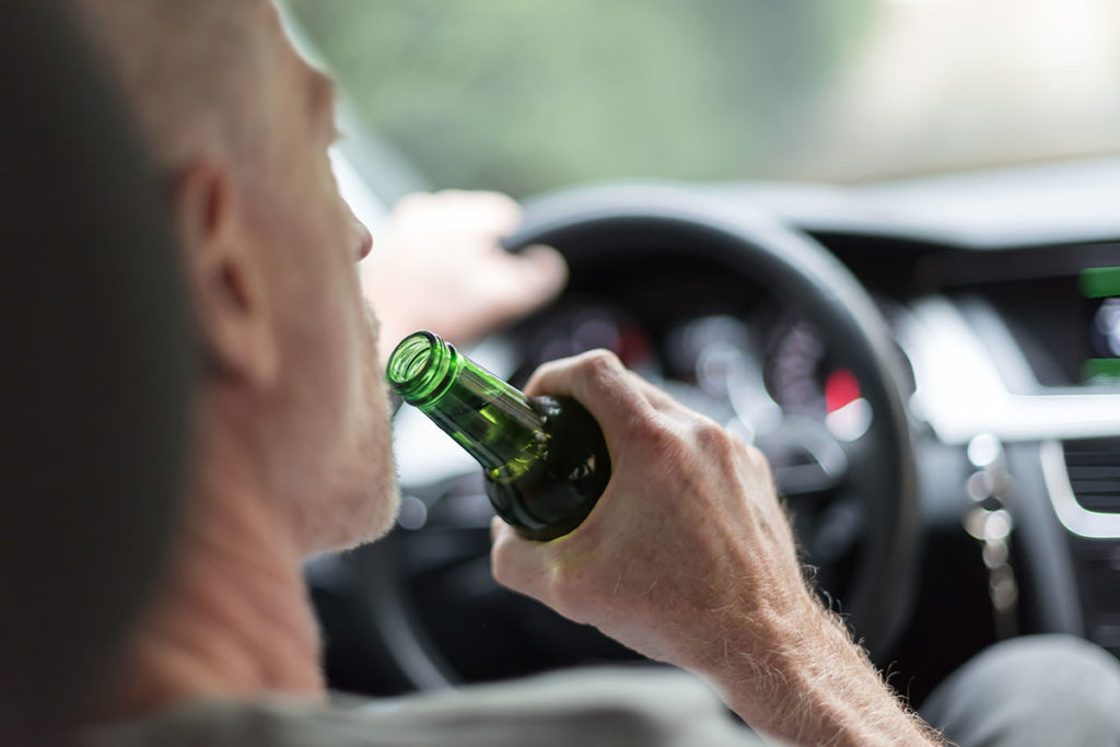 man drinking and driving