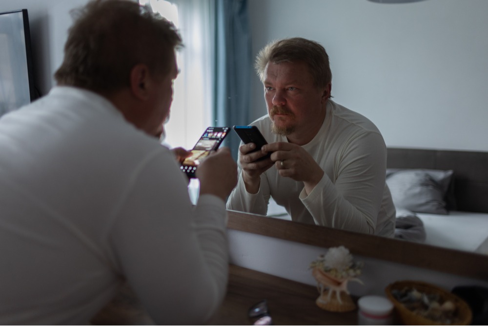 Man looking in the mirror getting ready for a life in recovery