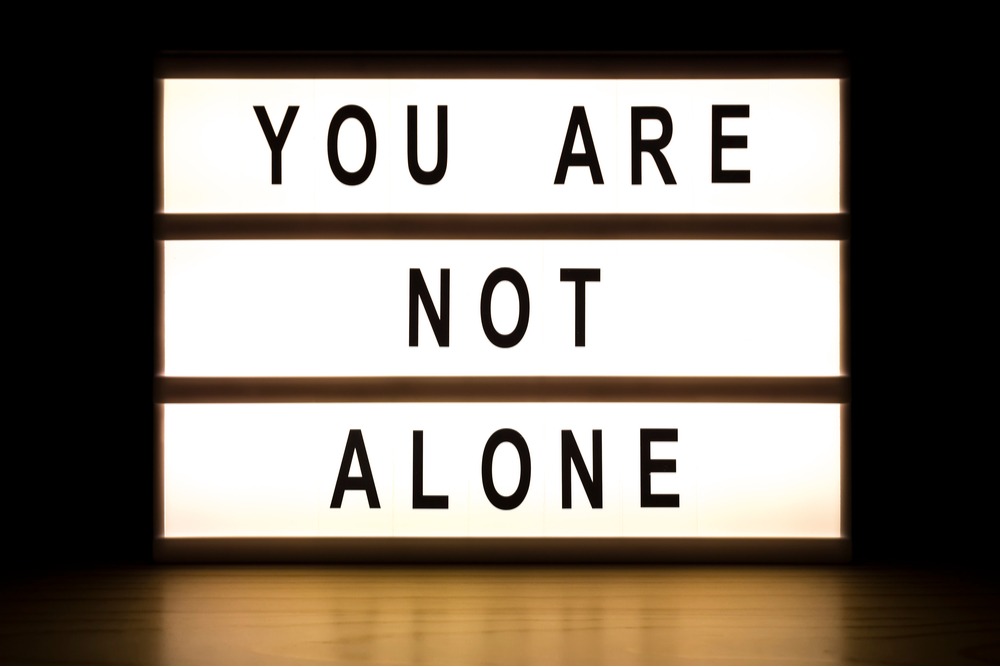 Letter board reads "You are not alone" for those going into detox and face obstacles in early recovery