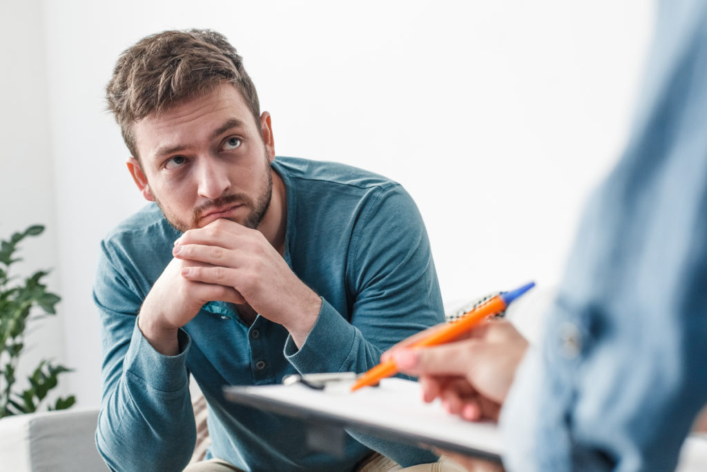 Man with therapist in flexible addiction treatment