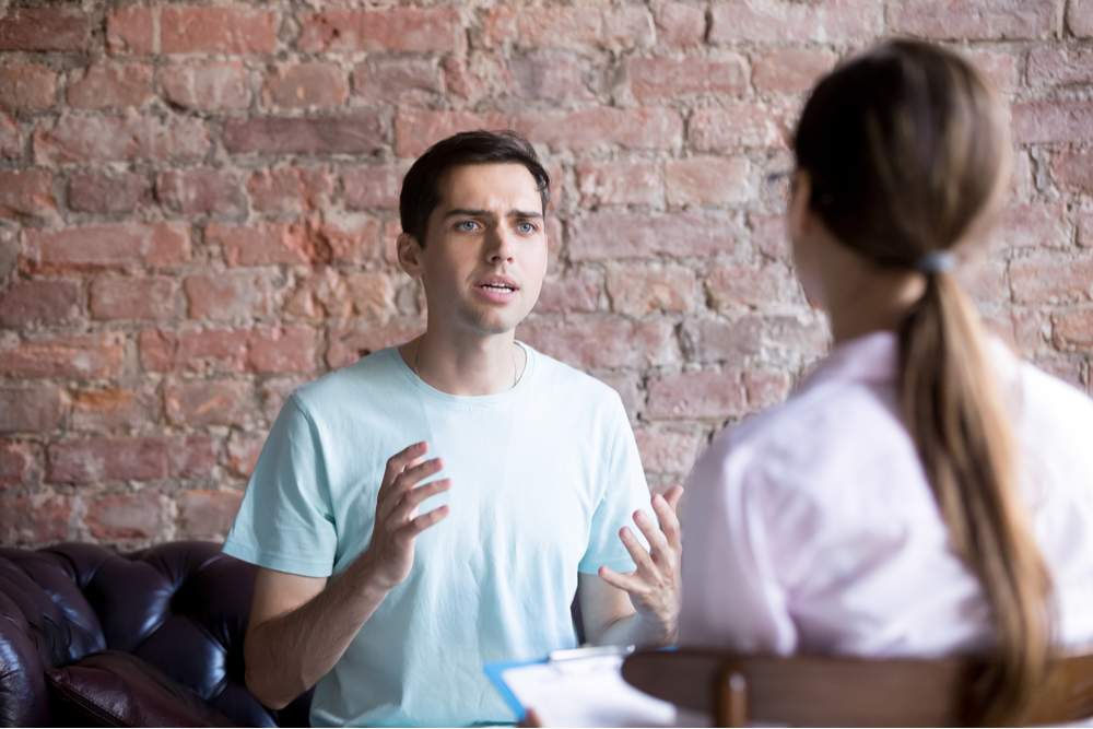 Man talking to therapist with recovery fears