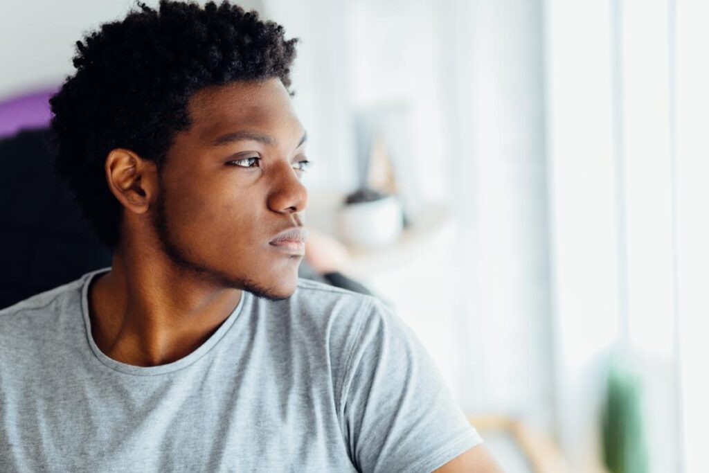 Teen pensive in sunny room, thinking about teen benzodiazepine addiction