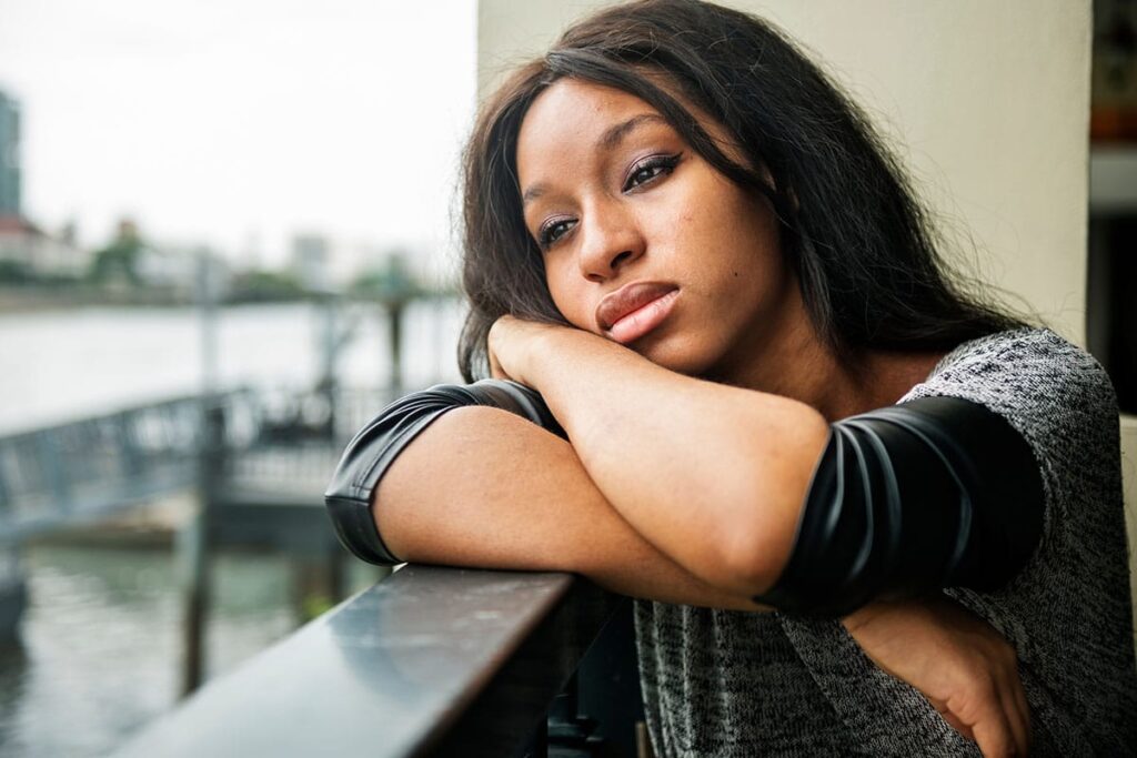 a person leans against a railing and wonders what is tranq