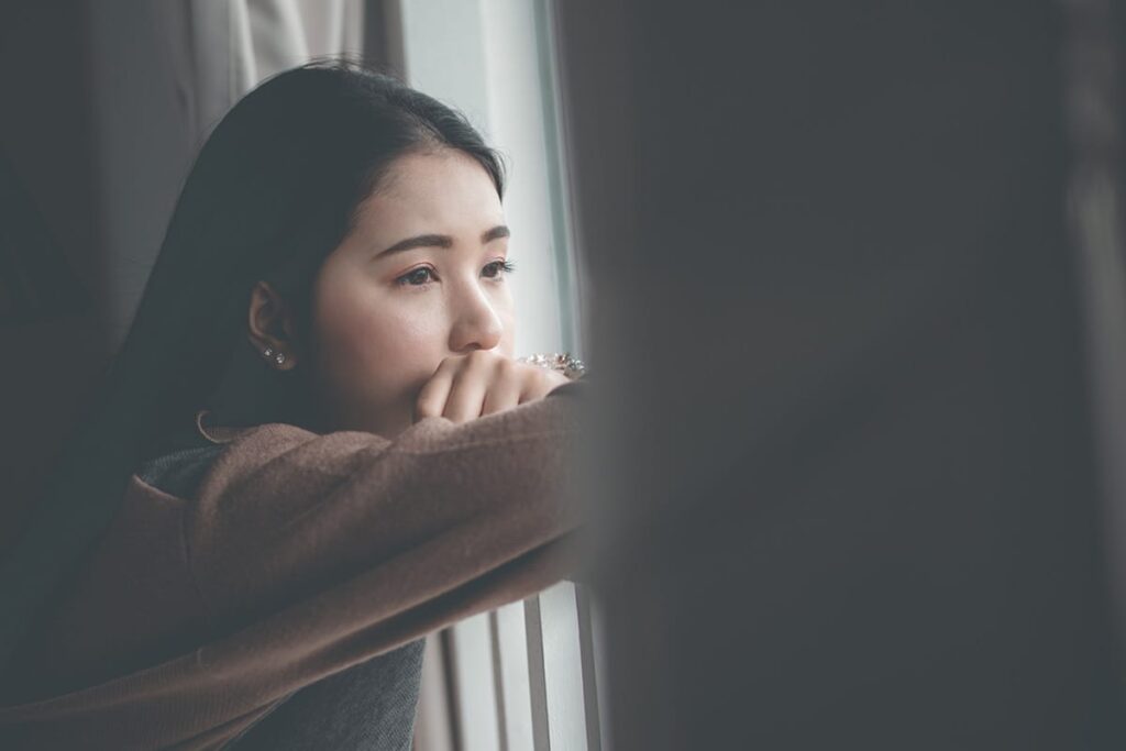 a young person looking out a window after learning about Borg Drinking