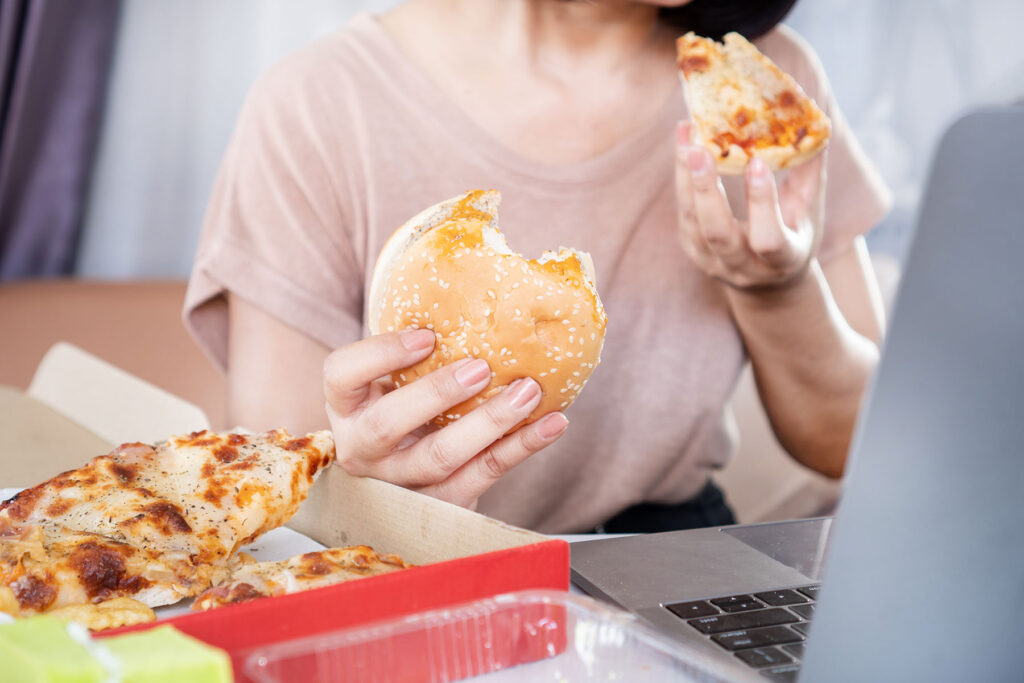 Person sits at table after smoking weed, wondering, "does marijuana make you hungry?"