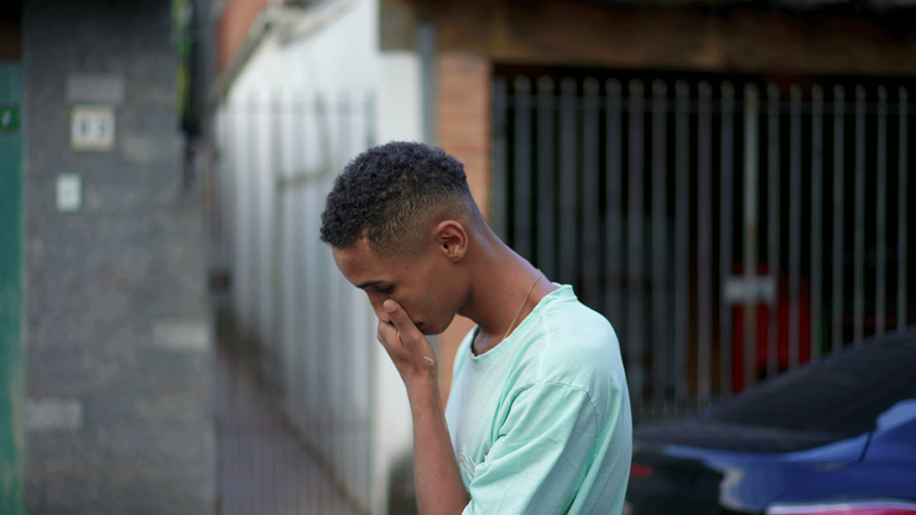 Man signs in agony while walking wondering why alcohol triggers PTSD