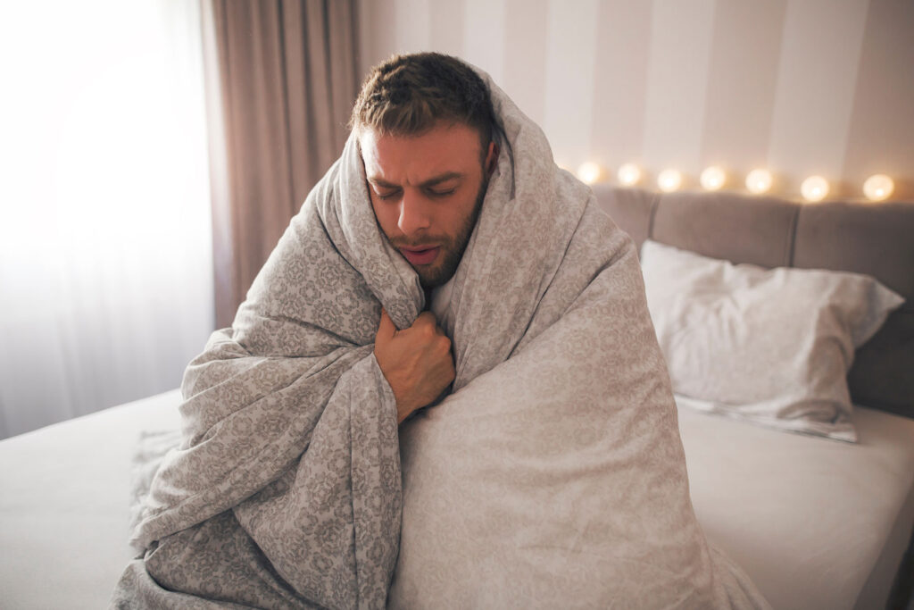 Person wrapped in blanket, wondering what dope sick is
