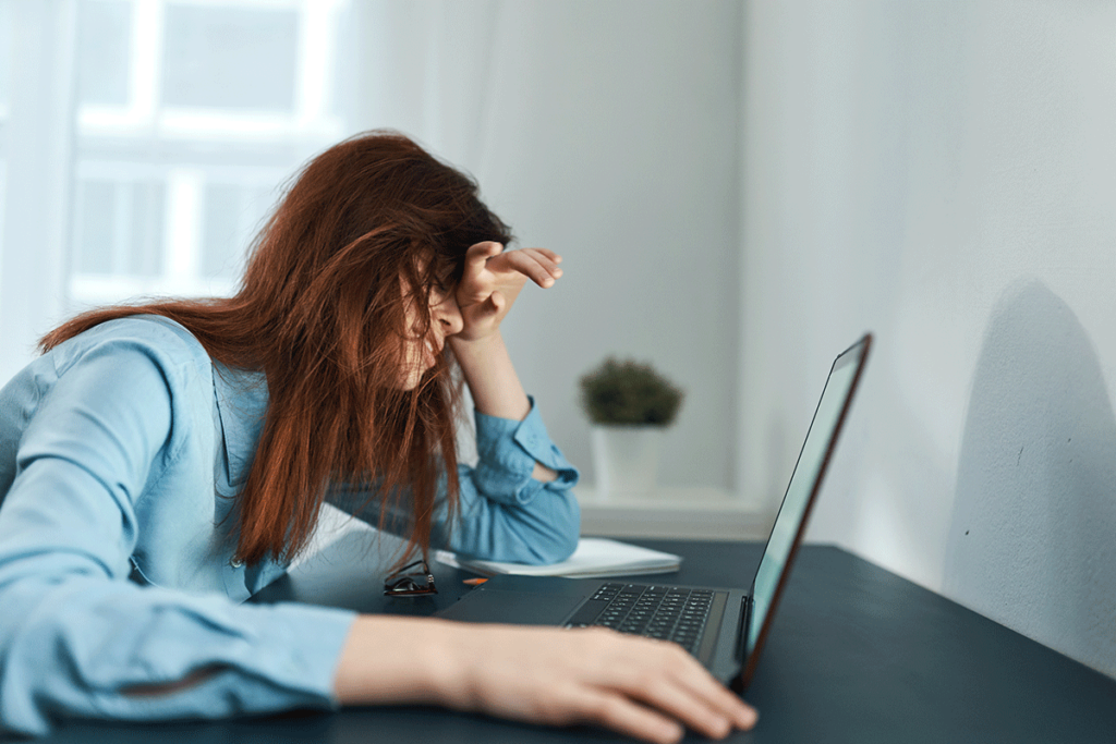 Woman struggles to type as she wonders about the link between borderline intellectual functioning and addiction