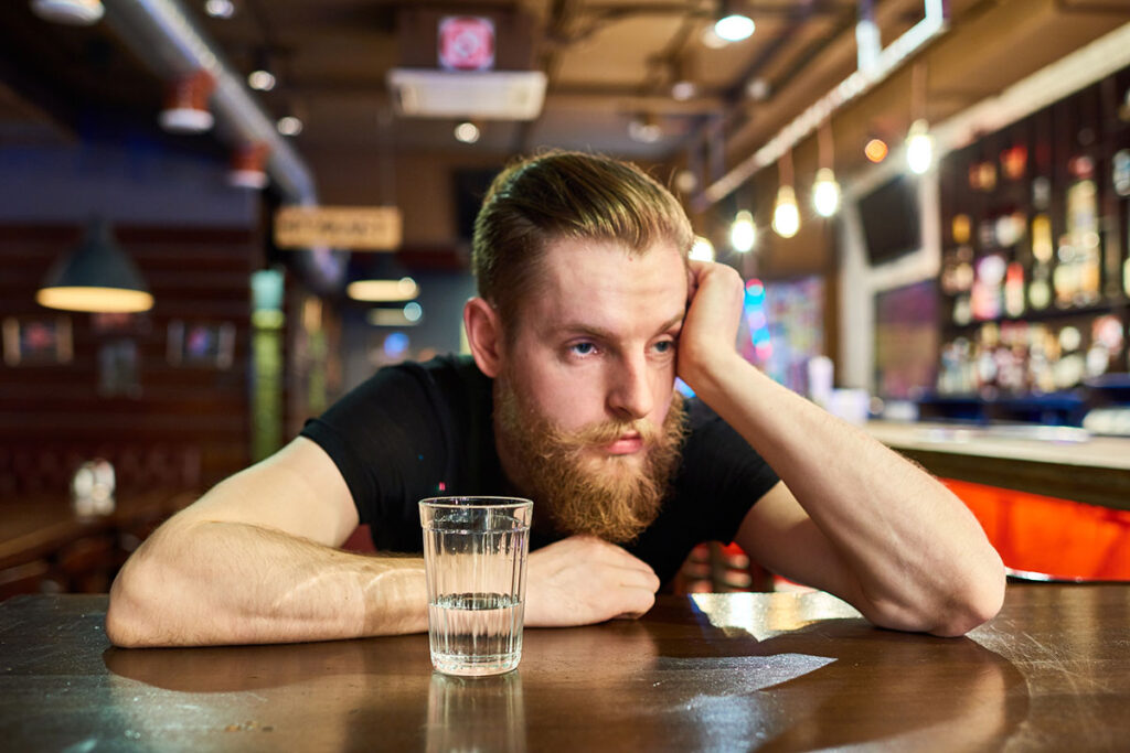 A man thinking about alcohol addiction in young adults