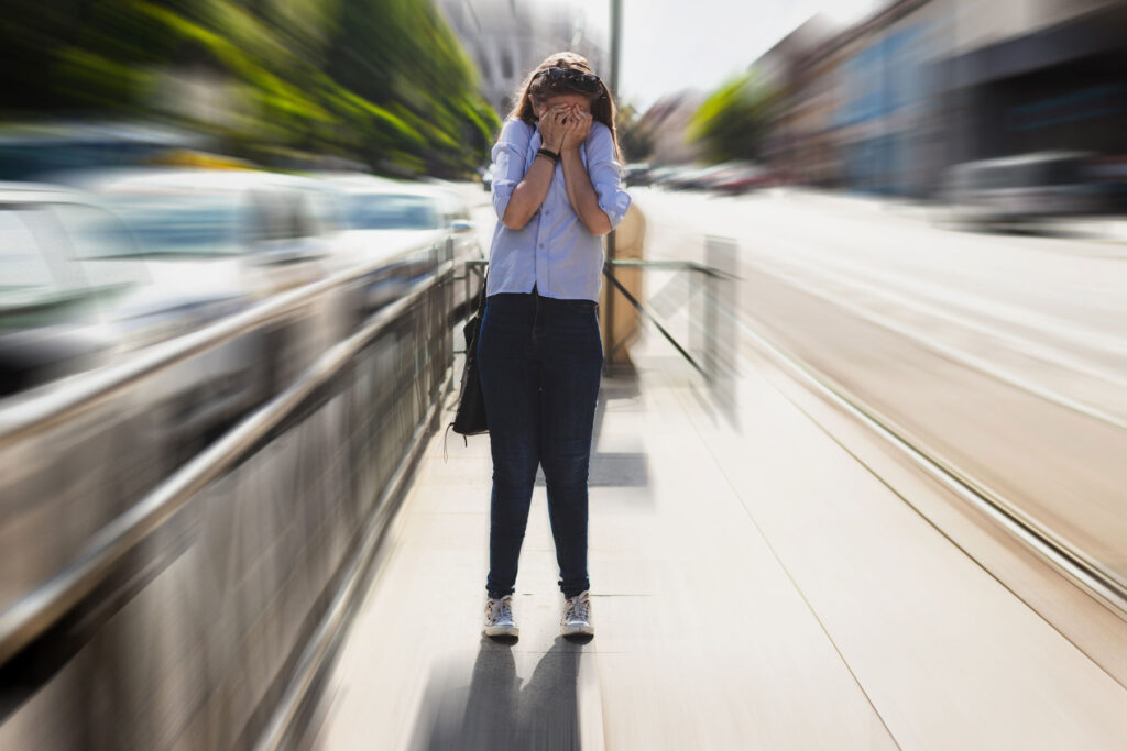 a woman struggles with anxiety symptoms in public