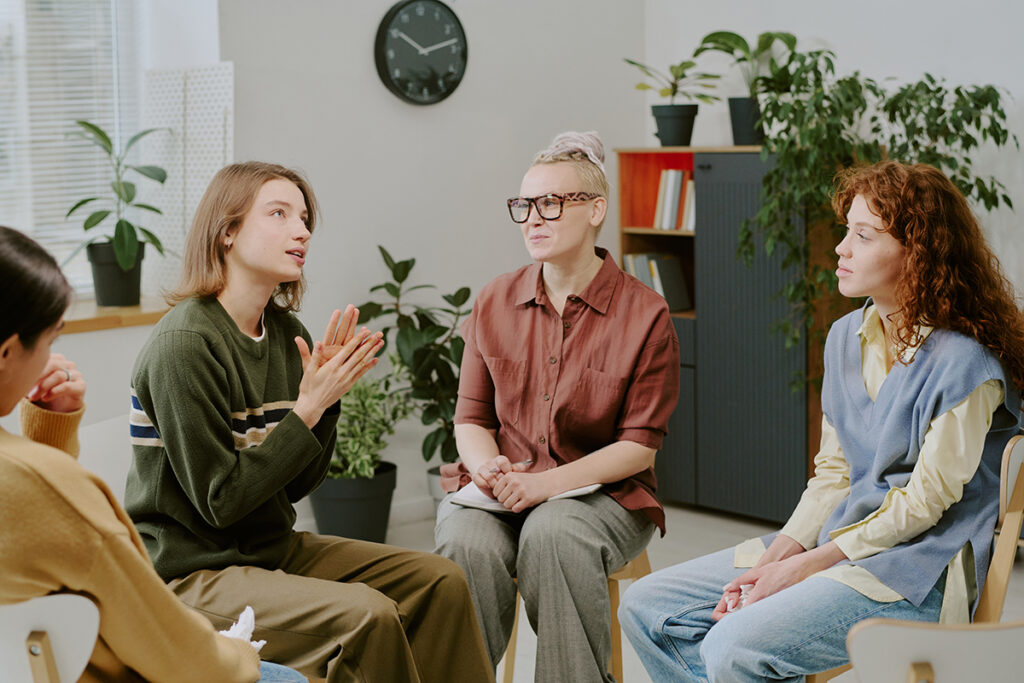Several people discuss aftercare programs for substance abuse